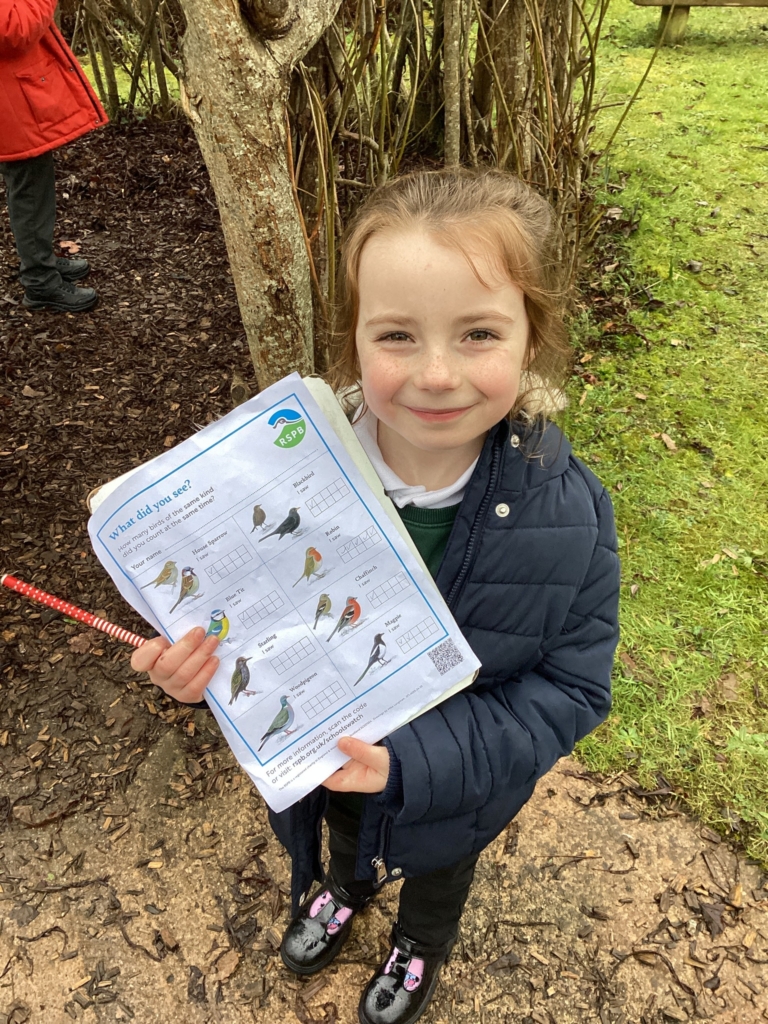 Exwick Heights Pupil holding a bird watch survey. 