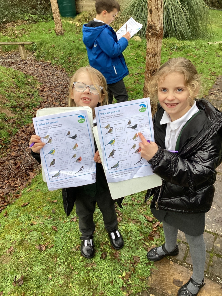 Two Exwick Heights Pupils holding a bird watch survey. 