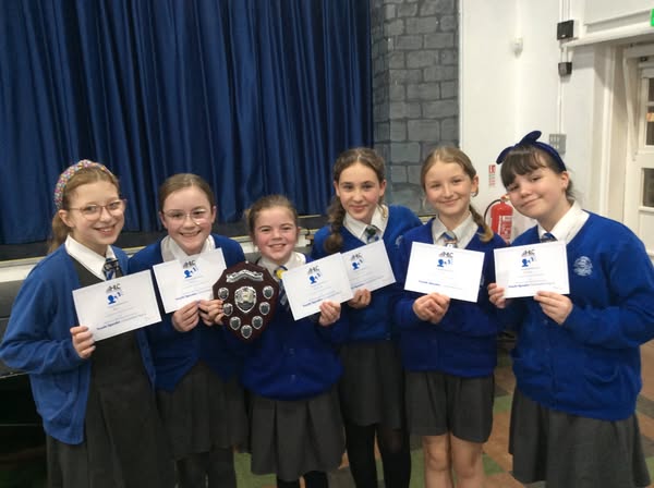 Students from Honiton Community College holding trophy and certificates from winning the Youth Speak Competition