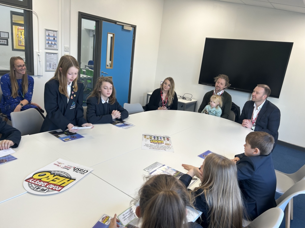 Marine Academy Primary  pupils sat at a table with MP Fred Thomas. 