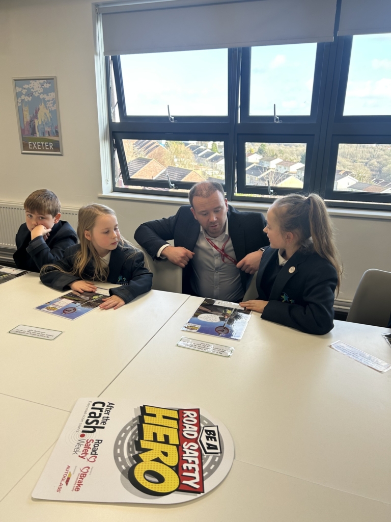 Marine Academy Primary  pupils sat at a table with MP Fred Thomas. 