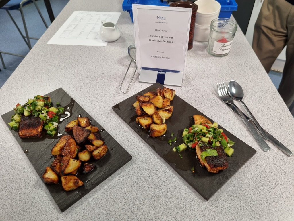 Food laid out ready to serve at the Rotary Young Chef Challenge - two plates of food on black slate