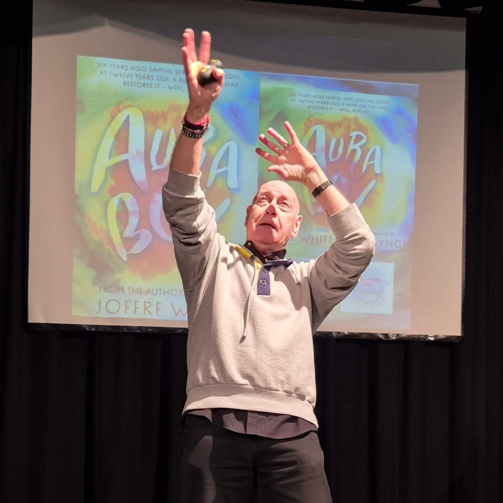 Author Joffre White on stage at Tor Bridge High