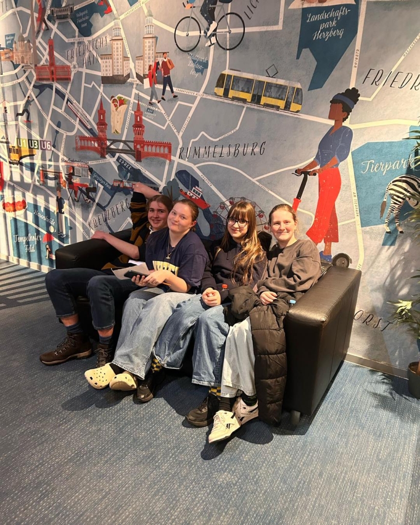 Isca students sightseeing in Berlin siting on a sofa