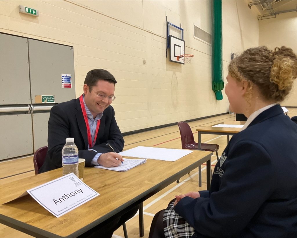 Student participating in a mock job interview as part of careers fair