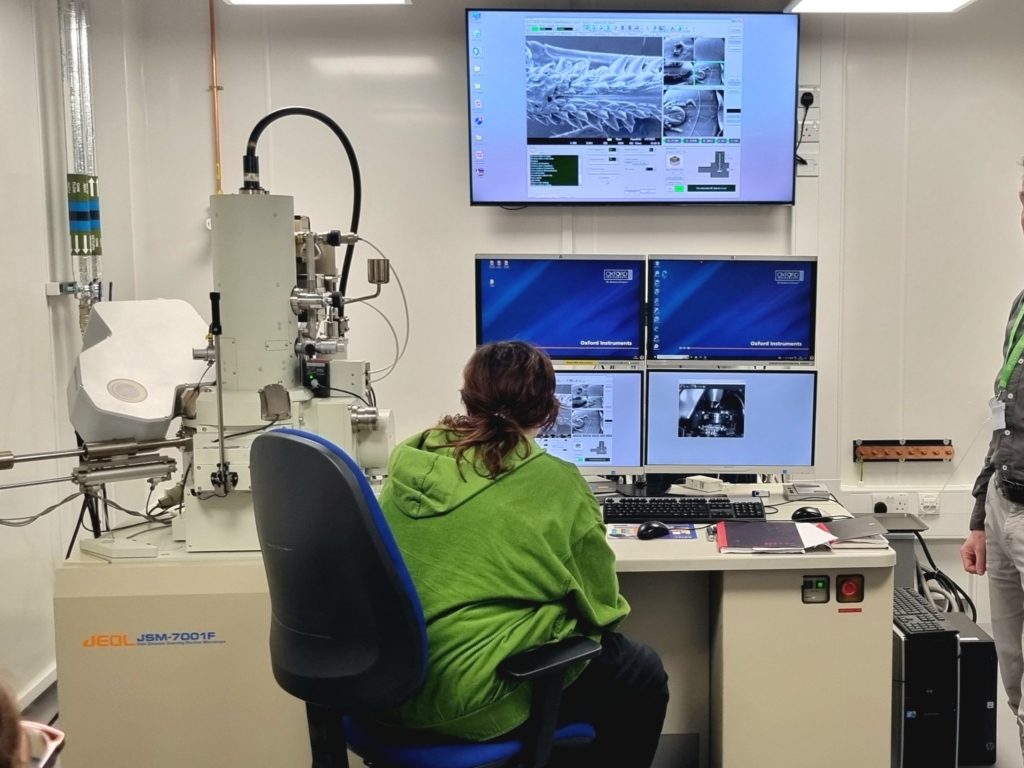 Students from Lipson sat at screens at the at the Plymouth Electron Microscopy Centre