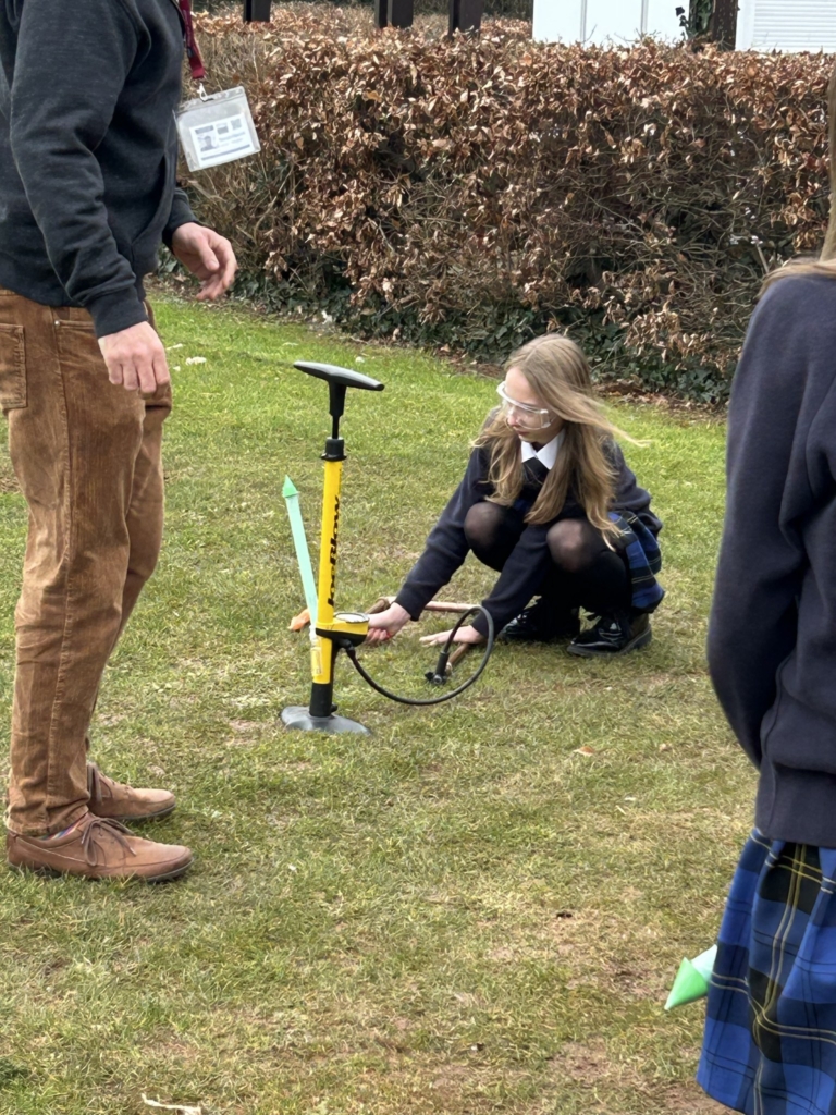 Year 7 and 8  students at West Exe School taking part in hands-on physics activities outside 