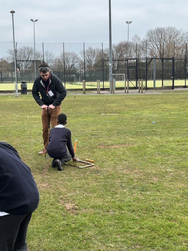 Year 7 and 8  students at West Exe School taking part in hands-on physics activities outside 