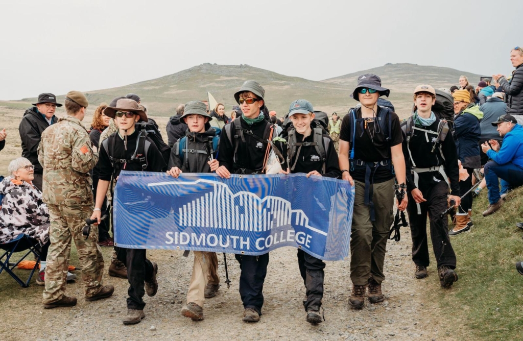 Sidmouth College Ten Tors Team walking with school flag