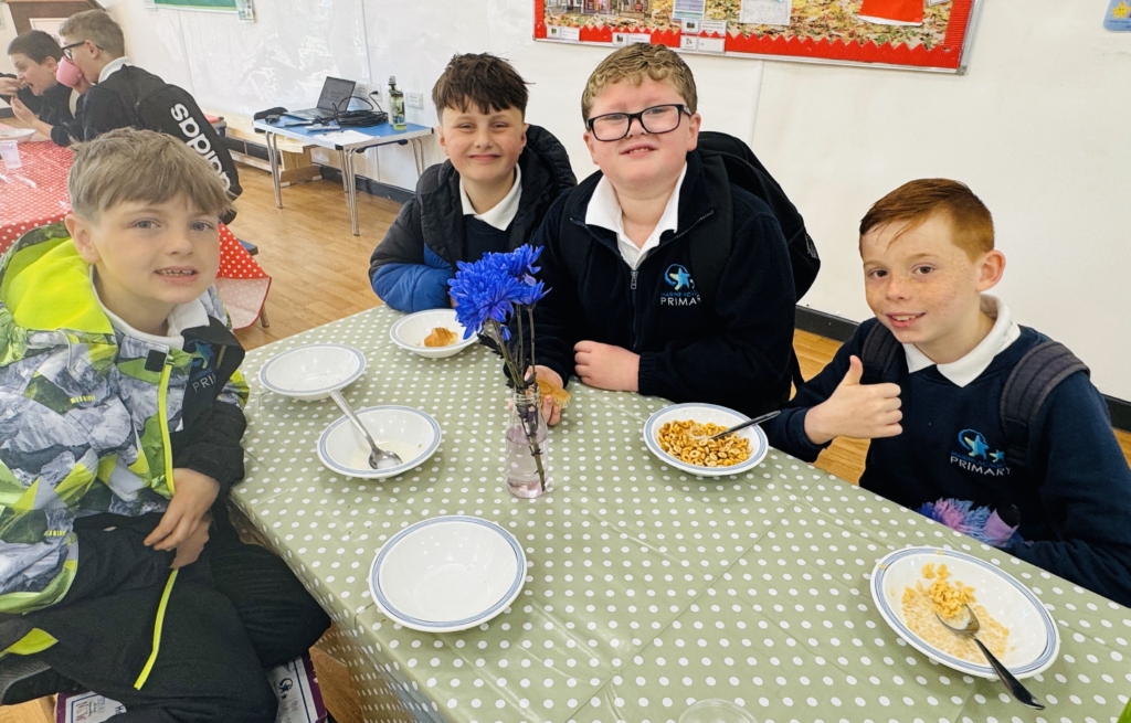 Students sat around a table enjoying a bowl of cereal