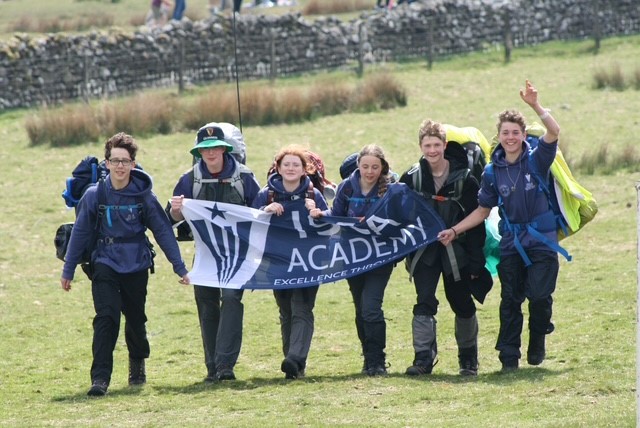 Isca Students holding the Isca flag and walking during the Ten Tors