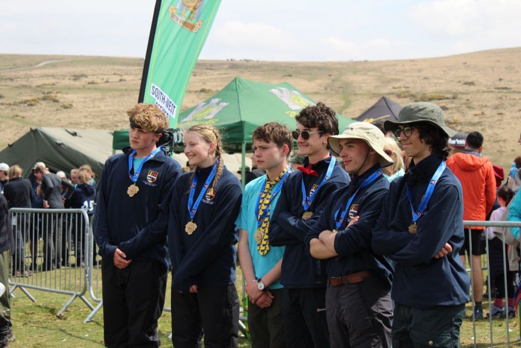 Pupils from Exmouth Community College standing in line receiving their Ten Tors medals