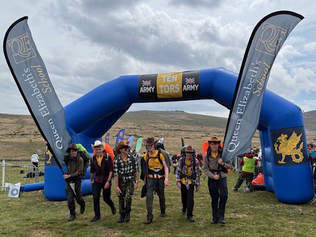 QE students finishing the Ten Tors with Cowboy hats on
