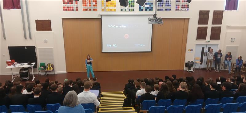 Students sat in rows watching a presentation on a board