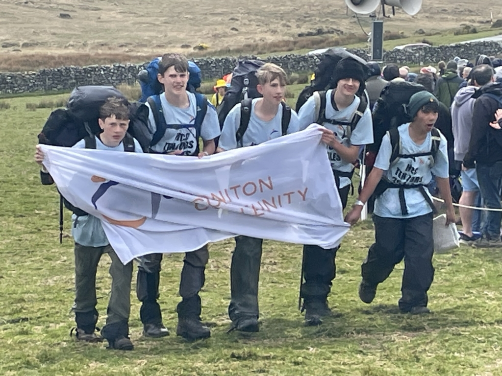 Honiton Community College Ten Tors teams walking with school flag