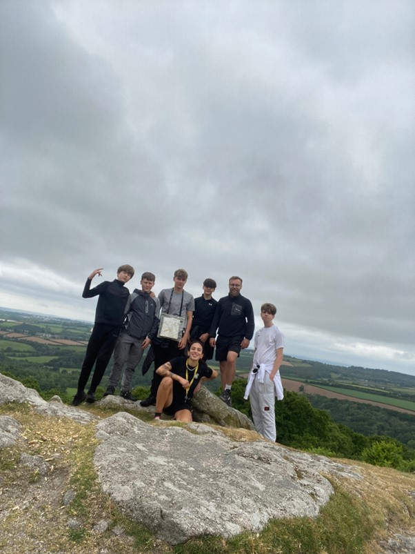 A group of students posing at the top of a Tor 