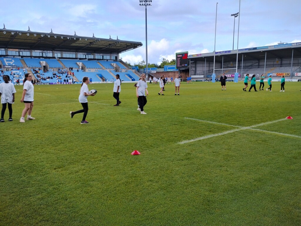 Children from Whipton Barton Federation running around the Exeter Chiefs ground. 