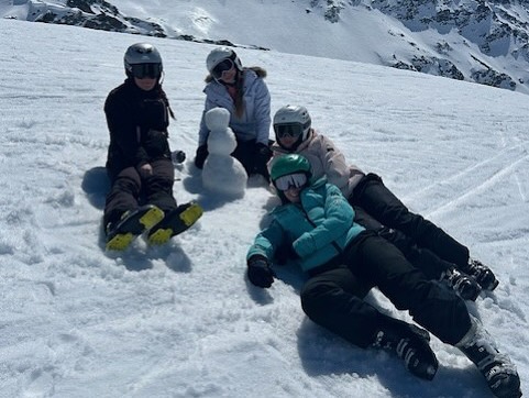 Exmouth Students  on the Ski slopes in Italy white snow all around making a snowman 