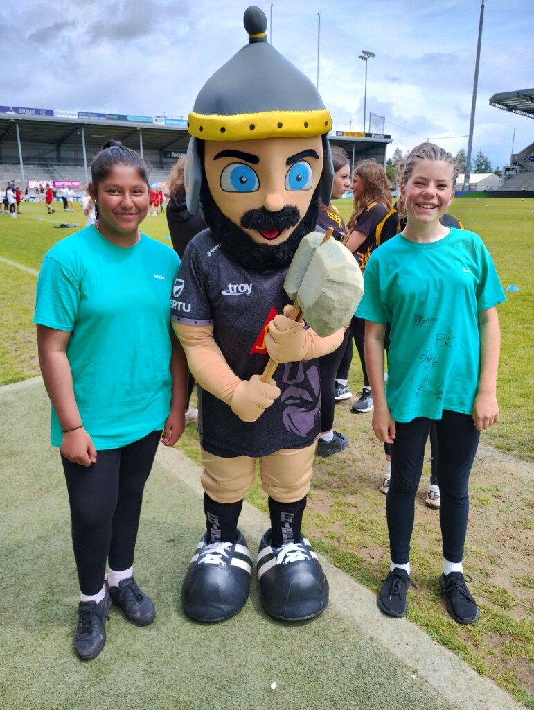 Children from Whipton Barton Federation stood with the Exeter Chiefs mascot at the ground. 