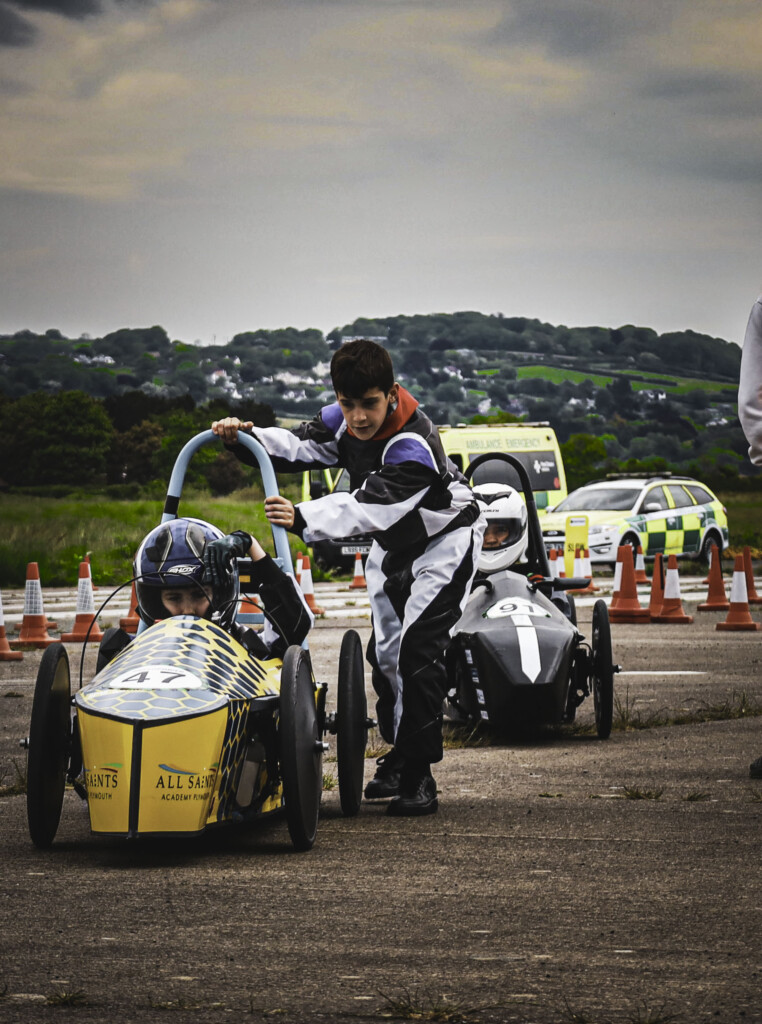 GreenPower engineering and racing team stood next to cars