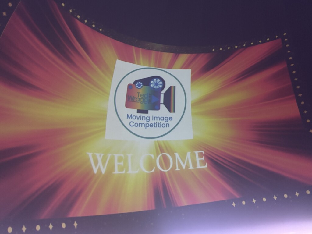 Image on a screen welcoming attendees to awards
