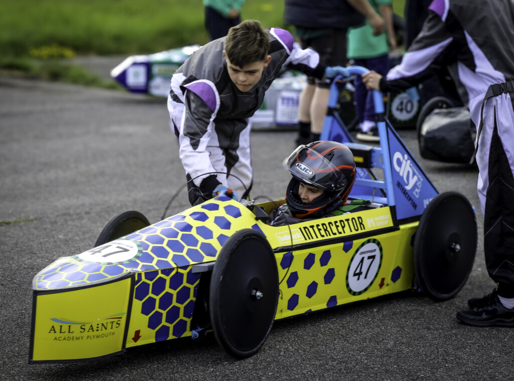 GreenPower engineering and racing team mates with car