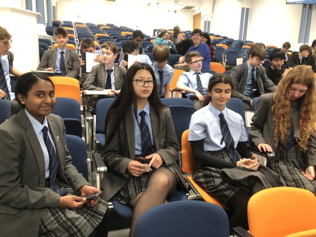 Students sat in blue chairs