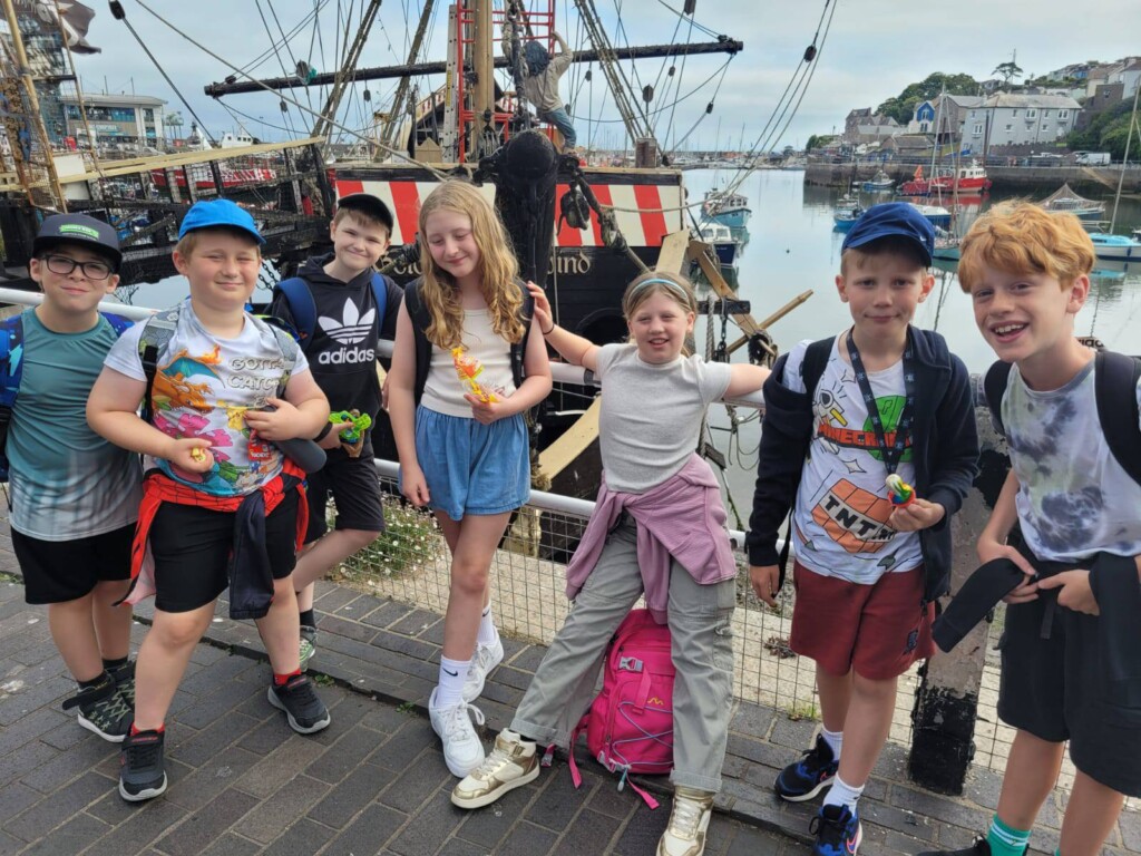 A small group of students stood at the harbour smiling