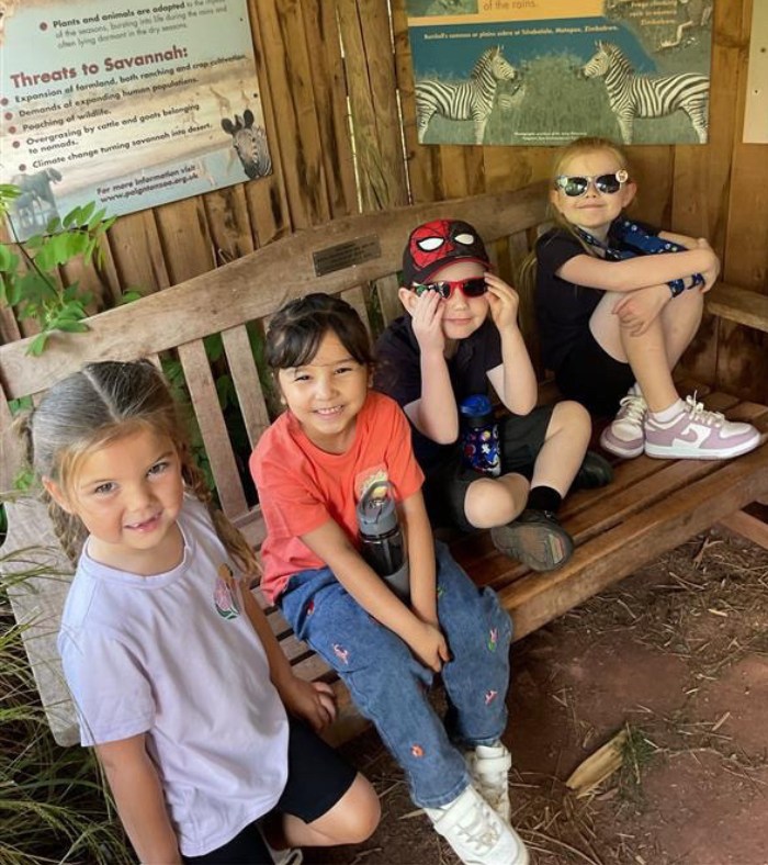 Matford Brook Academy Pupils sitting on a bench at Paignton Zoo 