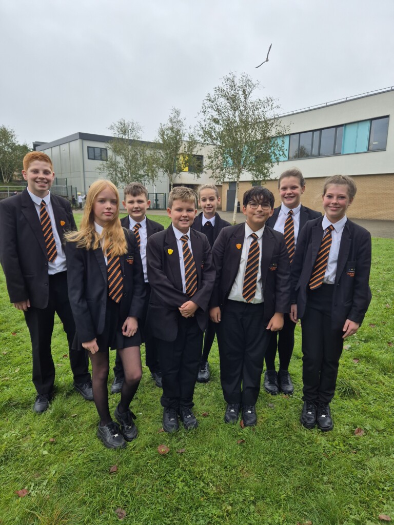 Students from Tor Bridge High stood outside part of the school building.