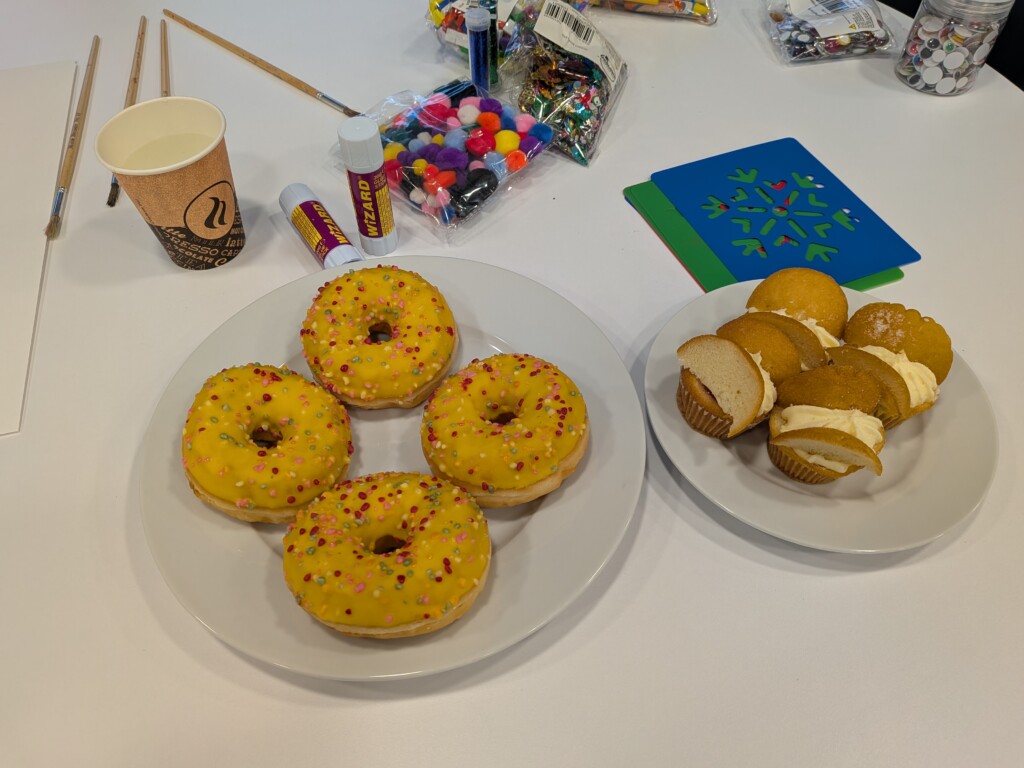 Burrington Community Hub new cafe opening a plate or doughnuts on the table.