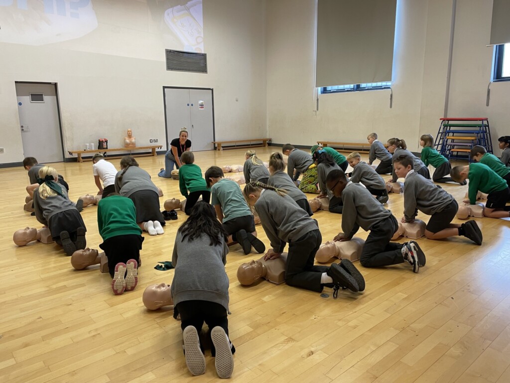 Pupils practicing CPR in workshop