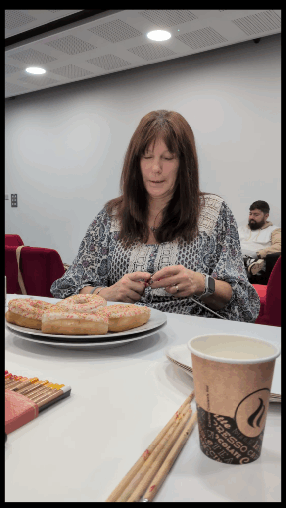 Burrington Community Hub new cafe opening with a lady sat at a table knitting