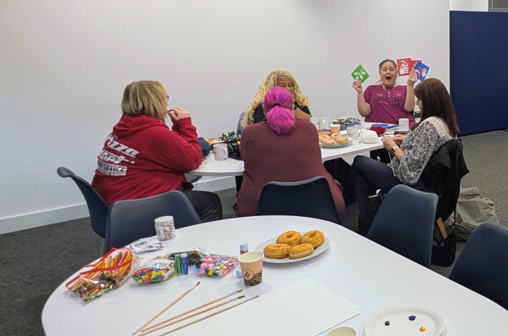 Burrington Community Hub new cafe the opening with people sat around a table  
