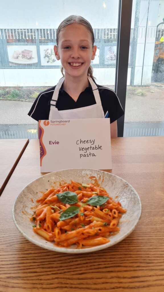 evie at her presentation table with food 