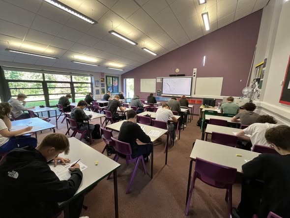 Sidmouth sixth formers sitting at desks taking the ukmt maths challenge