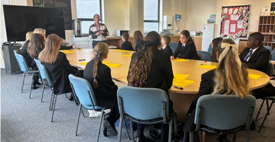 Students from St Luke's sat round the table speaking with a member from HeadsUP