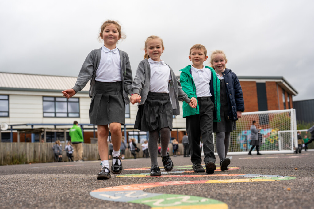 CEC Children holding hands and playing the playground