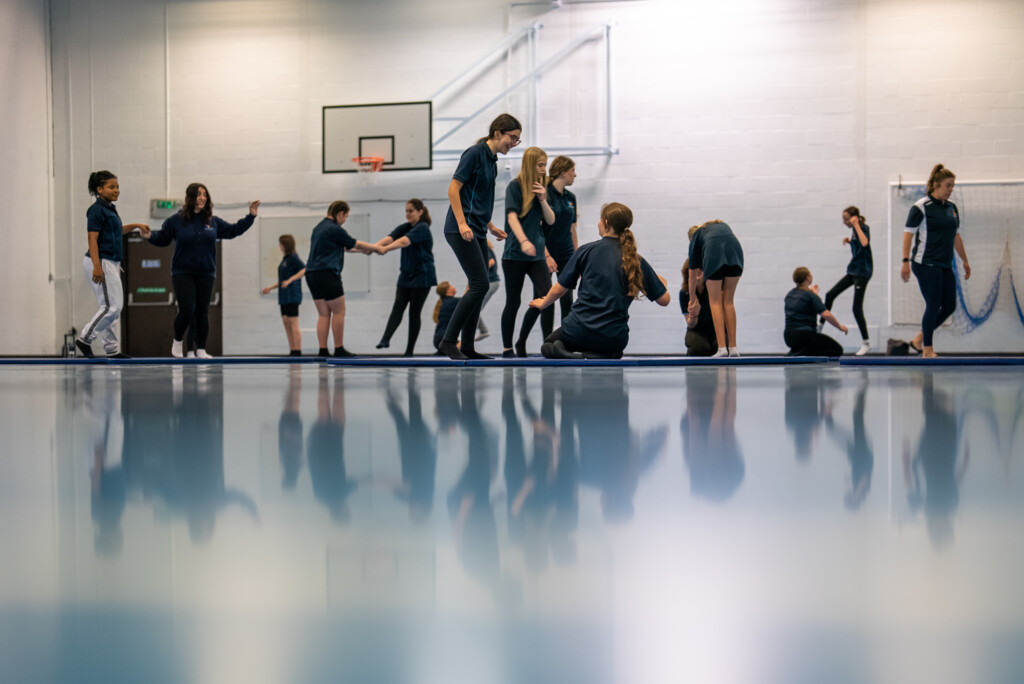 Marine Academy Plymouth Students moving around an indoor sports hall