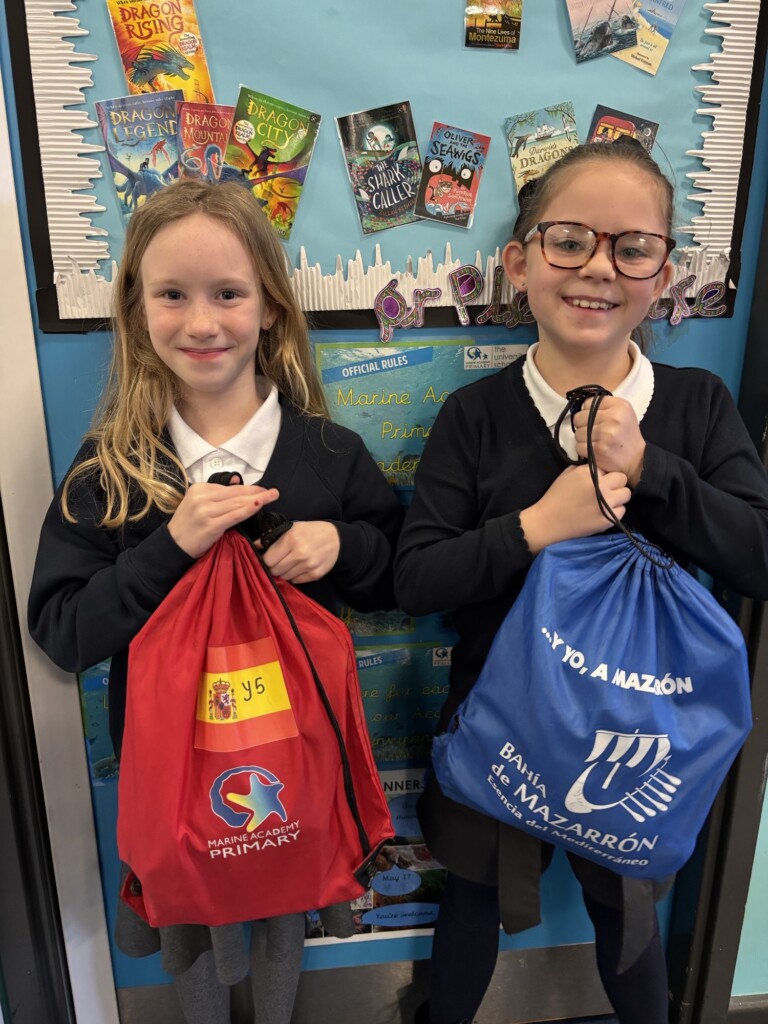 Two Marine Academy Pupils holding bags
