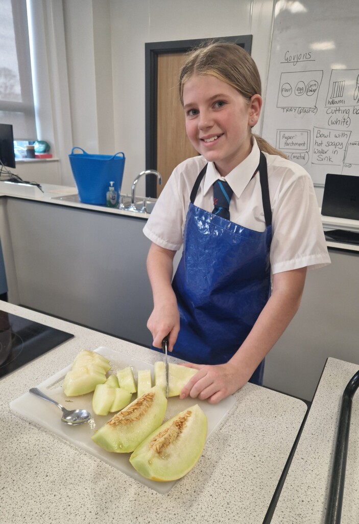 Exmouth Student chopping melon