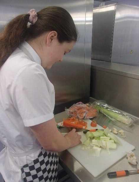 All Saints Students chopping veg in the kitchen