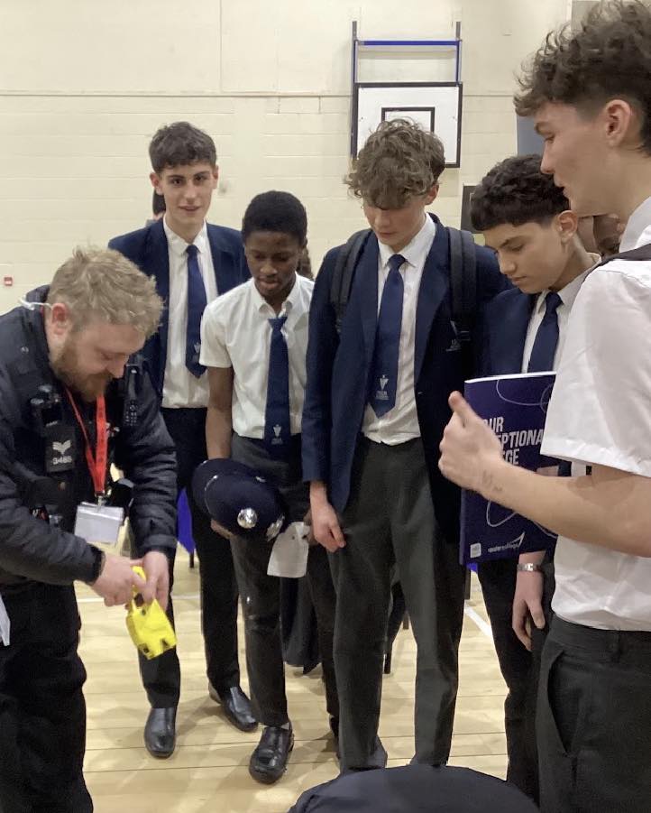 Isca students watching demonstration from police team as part of careers fair