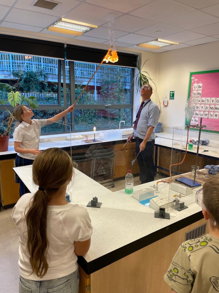 Teacher and student demonstrating experiment