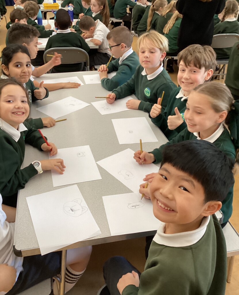 Children at Exwick Heights holding up their illustrations