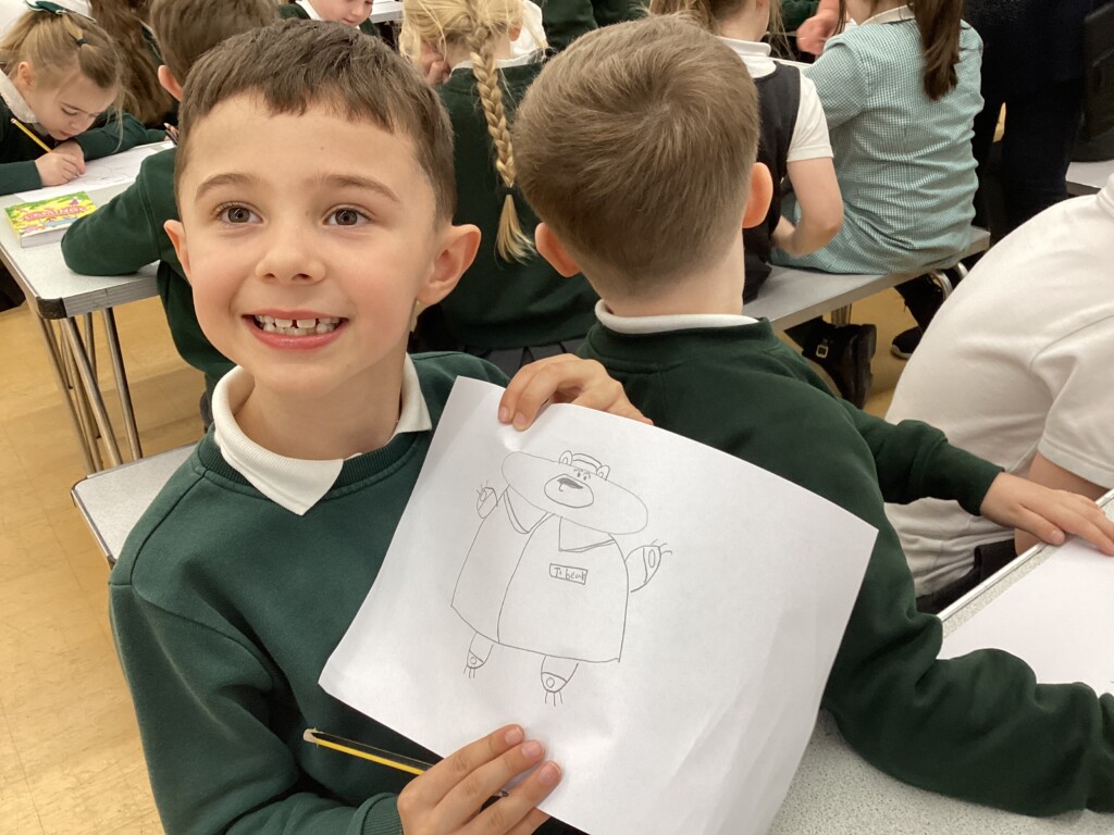 Children at Exwick Heights holding up their illustrations