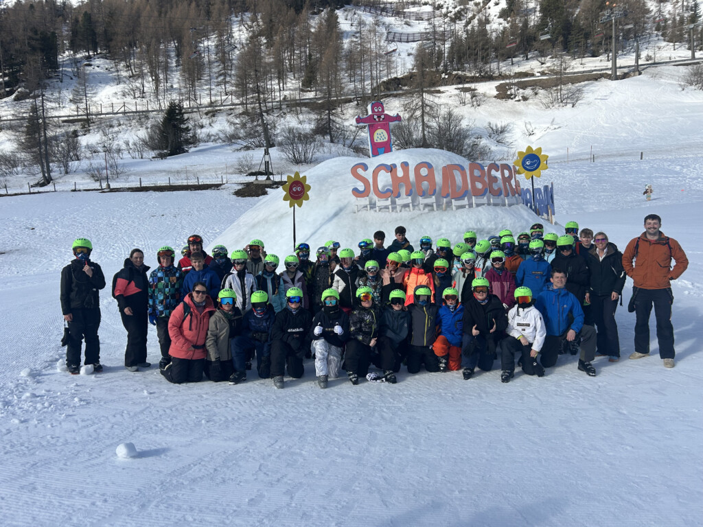 Group of students in ski gear posing for a group photo