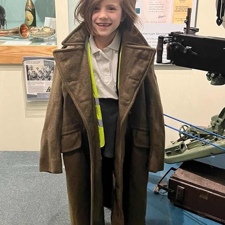 A pupil dressed up in a big coat