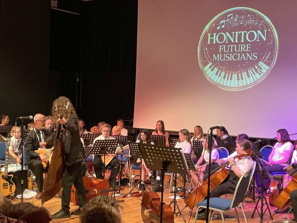 Students performing on stage playing instruments