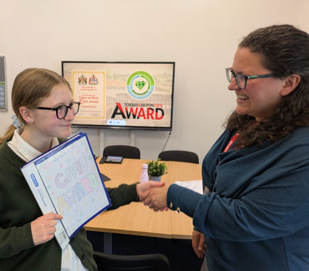 An Exwick Heights Pupil receiving her award